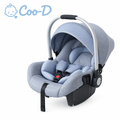 Coo-D branded newborn infant car seat carrier in soft blue-grey with canopy and carry handle